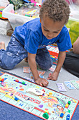 Little boy playing a game of Monopoly