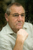 Portrait of an older man looking out of the window