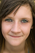 Portrait of a teenage girl smiling in the park