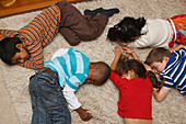 Multiracial group of children playing dead