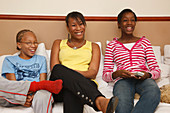 Family on sofa watching television