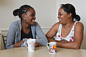 Teenage girl laughing with mother