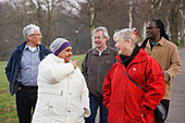 Group of people walking in a park and chatting
