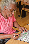 Elderly visually impaired woman playing bingo