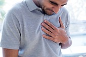 Man touching his chest in pain