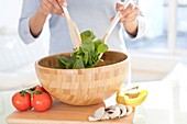 Woman making fresh salad