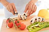 Woman chopping fresh mushrooms