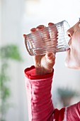 Close-up of woman drinking glass of water