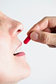 Close-up of a woman taking medication