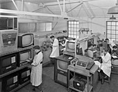 Technicians at work in TV repair in shop, 1959