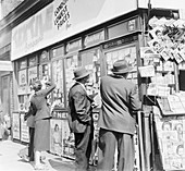 Advertisements in a newsagents window, c1955