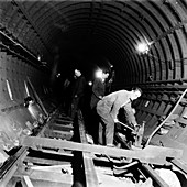 Repairing underground train tracks, London, 1955