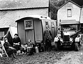 Family group with a 1925 Morris Oxford 14 28 and caravan