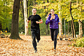 Happy couple jogging in park