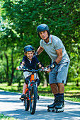 Grandfather teaching grandson how to ride a bike