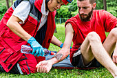 Medical worker treating burns on man's arm