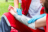 Medical worker treating burns on man's arm