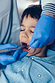 Dentist drilling young boy's tooth