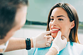 Dentist inspecting woman's teeth