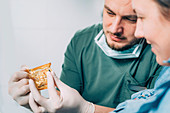 Dentist explaining dental implant procedure to patient