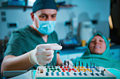 Dentist installing dental implant