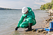 Water quality inspector filling up sample container