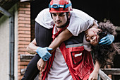 Rescue worker carrying woman