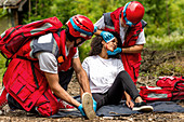 Rescue team helping injured woman