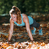 Woman doing push ups in the park