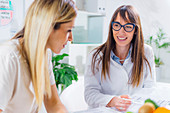 Nutritionist with female patient