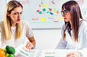 Nutritionist with female patient