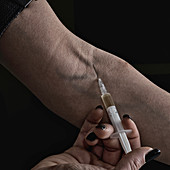 Woman injecting heroin