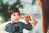 Homeopath giving remedy to child