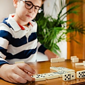 Boy playing dominoes