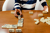 Boy playing dominoes