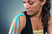 Woman with kinesiotape on shoulder