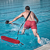 Lifeguard jumping into pool
