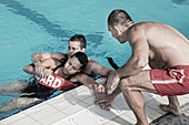 Lifeguards taking woman out of the pool