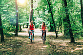 Two women cycling together