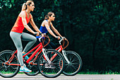 Two women cycling together