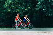 Two women cycling together