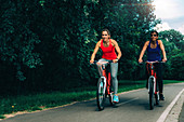 Two women cycling together