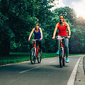 Two women cycling together