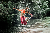 Female athlete jumping in a park