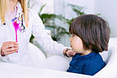 Paediatrician examining boy's eyesight