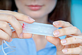 Researcher with lab on a chip