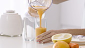 Woman pouring fruit juice