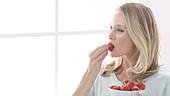 Woman eating fresh strawberries