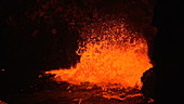 Lava spattering at night