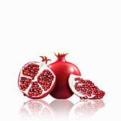 Whole and cut pomegranates, illustration